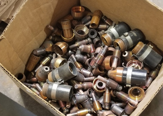 Box of conventional plasma consumables in various states of wear